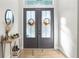 Charming front entrance with glass doors and seasonal wreaths at 7376 Fall St, Brooksville, FL 34613