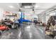 Spacious garage featuring a car lift, race car, multiple recreational vehicles, and epoxy flooring at 7376 Fall St, Brooksville, FL 34613