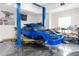 Garage featuring a blue car on a lift with tools and equipment, catering to automotive enthusiasts at 7376 Fall St, Brooksville, FL 34613