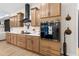 Bright kitchen with modern appliances, light wood cabinets, quartz countertops, and a sleek black range hood at 7376 Fall St, Brooksville, FL 34613