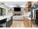Bright open kitchen with a large island, farm sink, and seamless flow into the cozy living area at 7376 Fall St, Brooksville, FL 34613