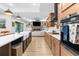 Spacious open-concept kitchen with an island, stainless steel appliances, and seamless flow into the living area at 7376 Fall St, Brooksville, FL 34613