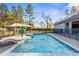 Backyard pool with tanning ledge, sun umbrella, and fenced in backyard at 7376 Fall St, Brooksville, FL 34613
