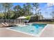 Gorgeous pool with a sun umbrella and lounge chairs creating a backyard oasis at 7376 Fall St, Brooksville, FL 34613