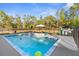 Backyard swimming pool, complete with tanning ledge and sun umbrella at 7376 Fall St, Brooksville, FL 34613