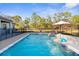 Inviting backyard pool with tanning ledge and sun umbrella at 7376 Fall St, Brooksville, FL 34613