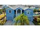 Two-story waterfront home with double garage and palm trees at 7516 Gulf Way, Hudson, FL 34667