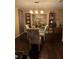Dining room with hardwood floors, glass-top table, and built-in shelving at 140 Callaway Ave, Spring Hill, FL 34606