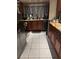 Kitchen with wood cabinets, granite countertops, and tile flooring at 140 Callaway Ave, Spring Hill, FL 34606
