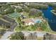 Aerial view of community clubhouse, pool, and tennis courts at 4808 Vesper Ct, New Port Richey, FL 34655