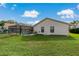 Home features a screened pool and fenced backyard with lush grass at 591 Waterford W Cir, Tarpon Springs, FL 34688