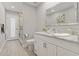 Modern bathroom with white vanity, marble countertop, and glass shower at 591 Waterford W Cir, Tarpon Springs, FL 34688