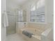 Relaxing bathroom with a large soaking tub and walk-in shower at 591 Waterford W Cir, Tarpon Springs, FL 34688