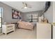 Well-lit bedroom with a twin bed and plenty of closet space at 591 Waterford W Cir, Tarpon Springs, FL 34688