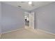 Cozy bedroom with neutral walls and an open door to hallway at 591 Waterford W Cir, Tarpon Springs, FL 34688