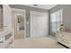 Spacious bedroom with a double door closet and view into hallway at 591 Waterford W Cir, Tarpon Springs, FL 34688