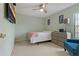 Charming bedroom with a queen-size bed and a teal armchair at 591 Waterford W Cir, Tarpon Springs, FL 34688