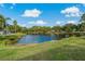 Scenic backyard view of a peaceful lake at 591 Waterford W Cir, Tarpon Springs, FL 34688