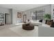 Living room features white sofas, a coffee table, and an entryway at 591 Waterford W Cir, Tarpon Springs, FL 34688