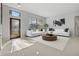 Bright living room with white sofas, a coffee table, and large windows at 591 Waterford W Cir, Tarpon Springs, FL 34688