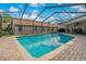 Inviting, screened pool with brick pavers at 591 Waterford W Cir, Tarpon Springs, FL 34688