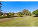 Spacious backyard with a large grassy area at 13235 Legends Trl, Dade City, FL 33525