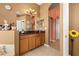 Bathroom with double vanity and dark countertop at 13235 Legends Trl, Dade City, FL 33525