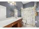 Clean bathroom with a single sink vanity, toilet, and shower at 13235 Legends Trl, Dade City, FL 33525