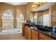 Bathroom with a large soaking tub and double vanity at 13235 Legends Trl, Dade City, FL 33525