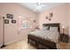 Bedroom with a king-size bed, window, and decorative wall accents at 13235 Legends Trl, Dade City, FL 33525