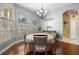 Charming dining room with hardwood floors and a round table at 13235 Legends Trl, Dade City, FL 33525