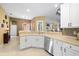 Modern kitchen with stainless steel appliances and white cabinets at 13235 Legends Trl, Dade City, FL 33525