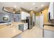 Spacious kitchen with stainless steel appliances and a breakfast bar at 13235 Legends Trl, Dade City, FL 33525