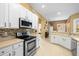 Modern kitchen with stainless steel appliances and light-colored cabinetry at 13235 Legends Trl, Dade City, FL 33525