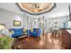 Living room boasts hardwood floors and a view to the dining area at 13235 Legends Trl, Dade City, FL 33525
