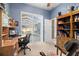 Home office with built-in shelving, a view of the pool, and a rocking chair at 13235 Legends Trl, Dade City, FL 33525