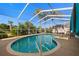 Inviting kidney-shaped pool with a screened enclosure at 13235 Legends Trl, Dade City, FL 33525