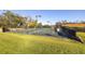 Tennis courts with surrounding trees and landscaping at 13235 Legends Trl, Dade City, FL 33525