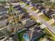 Aerial view of neighborhood homes with pools and lush landscaping at 692 Challice Dr, Spring Hill, FL 34609