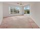 Spacious bedroom with large windows and access to a private patio at 1091 Dartford Dr, Tarpon Springs, FL 34688