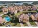 Aerial view of townhome near pool and lake at 1545 Citrine Trl, Tarpon Springs, FL 34689