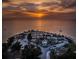 Sunset aerial view of waterfront park with beach,gazebo, parking and surrounding water at 1545 Citrine Trl, Tarpon Springs, FL 34689