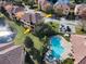 Aerial view of townhome with pool and lake at 1545 Citrine Trl, Tarpon Springs, FL 34689