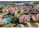 Aerial view of community with pool and lake at 1545 Citrine Trl, Tarpon Springs, FL 34689