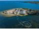 Aerial view of island park with beach, parking and boat at 1545 Citrine Trl, Tarpon Springs, FL 34689