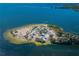 Aerial view of island park with beach, parking, and surrounding water at 1545 Citrine Trl, Tarpon Springs, FL 34689