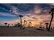 Beachfront gazebo at sunset with palm trees and people enjoying the view at 1545 Citrine Trl, Tarpon Springs, FL 34689