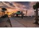 Beachfront gazebo at sunset with palm trees and people enjoying the view at 1545 Citrine Trl, Tarpon Springs, FL 34689