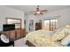 Bright bedroom with a queen-size bed and private access to a balcony at 1545 Citrine Trl, Tarpon Springs, FL 34689