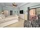 Spacious bedroom with a king-size bed, sitting area, and private balcony access at 1545 Citrine Trl, Tarpon Springs, FL 34689